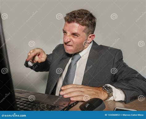 Angry Exploited Businessman At Office Desk Stressed And Frustrated With
