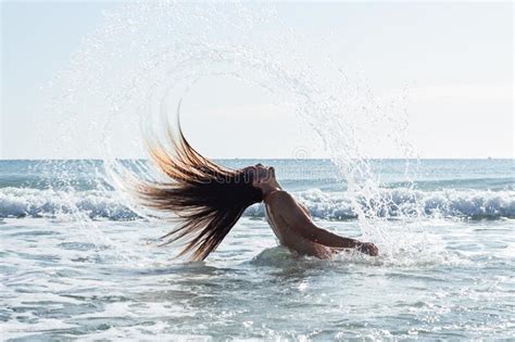 Closeup Shot Of A Young Man With Long Hair Doing A Hair Flip In The