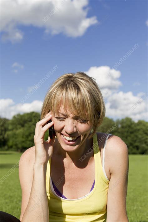 Woman Laughing On Cell Phone Outdoors Stock Image F Science Photo Library