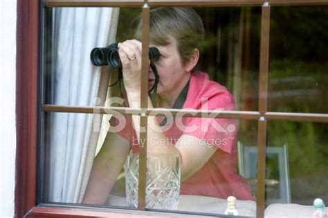 Nosey Neighbour At The Window With Binoculars Stock Photos
