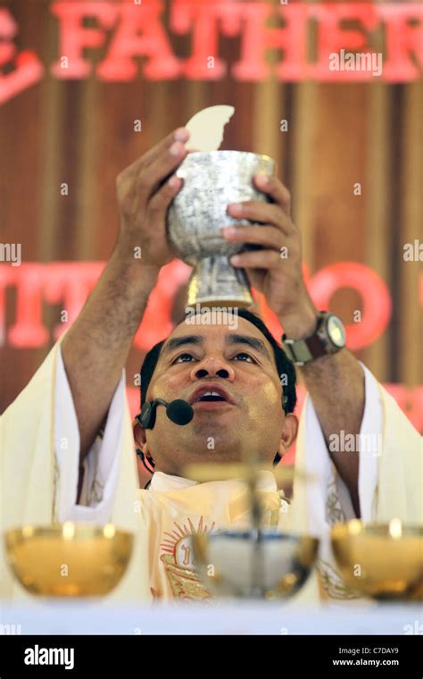 Roman Catholic Priest Consecrating Host And Goblet Papua New Guinea