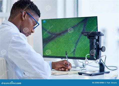 Doing A Whole Lot Of Research A Focused Young Male Scientist Making