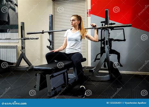 Serious Sportswoman Sitting In A Gym On A Simulator Stock Image Image
