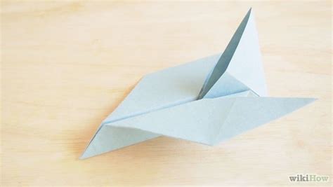 An Origami Bird Sitting On Top Of A Wooden Table