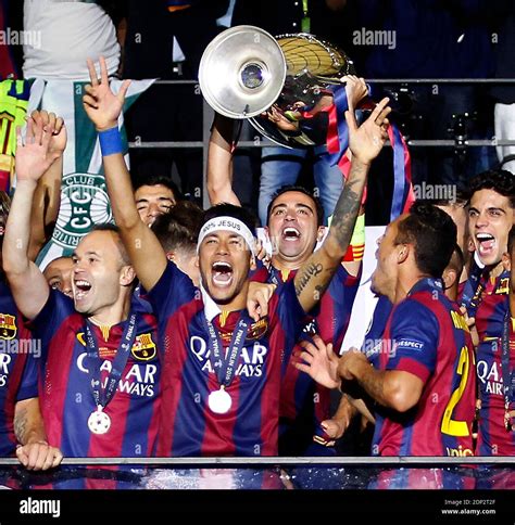 Barcelona Players Lift The Uefa Champions League Trophy On The Balcony