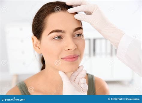 Dermatologist Examining Patient`s Face In Clinic Stock Photo Image Of