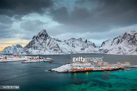 Snow Covered Norwegian Landscape With Island Of Sakrisøy Village In