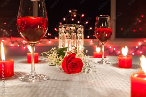 Romantic Dinner With Wine Candles And A Red Rose On A Table Stock