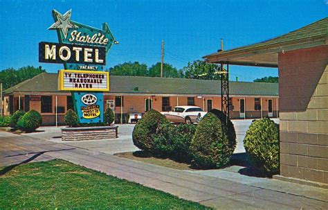 A Motel Sign In Front Of A Parking Lot
