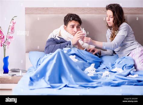 Wife Caring For Sick Husband At Home In Bed Stock Photo Alamy