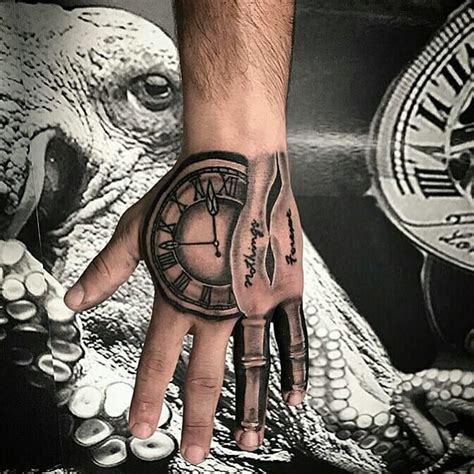 A Mans Hand With A Clock Tattoo On It
