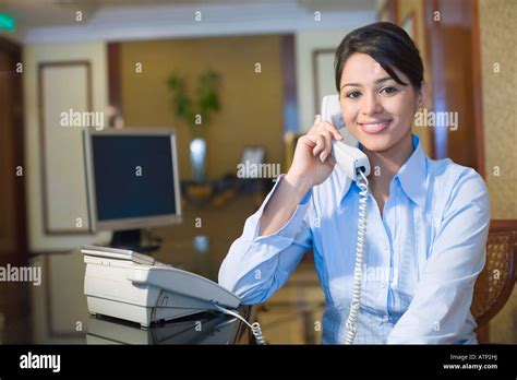 Portrait Of A Female Receptionist Sitting At A Hotel Reception And