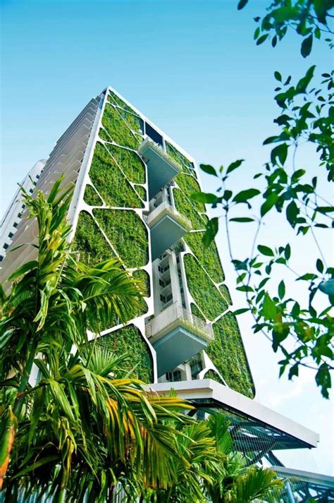 A Tall Building With Plants Growing On It S Side And The Top Part Of