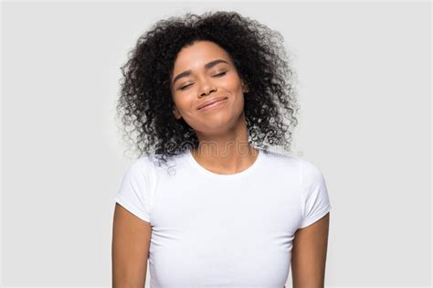 Satisfied African American Woman Enjoying Dreaming With Closed Eyes