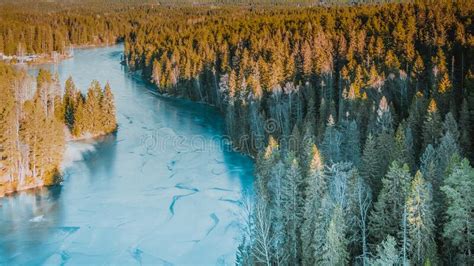 Aerial View Of A Frozen Lake In The Middle Of A Scandinavian Forest N
