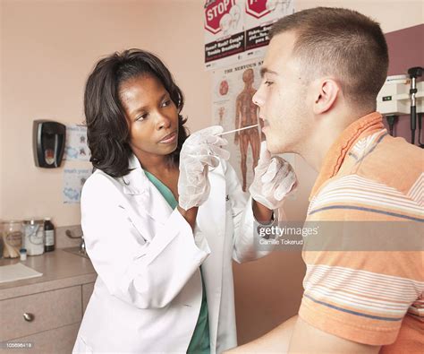 Female Doctor Doing An Exam On Teen Male Patient Photo Getty Images