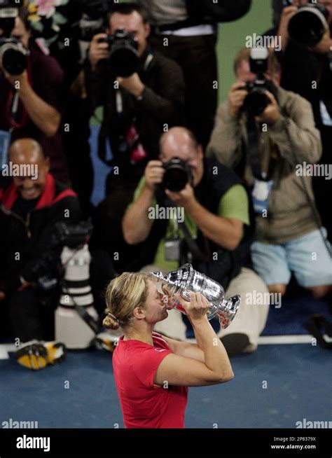 Kim Clijsters Of Belgium Kisses Her Trophy After Winning The Womens
