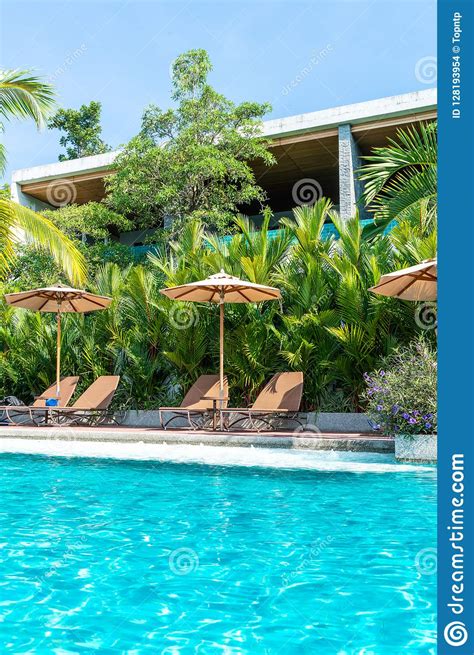 Beautiful Umbrella And Chair Around Swimming Pool In Hotel