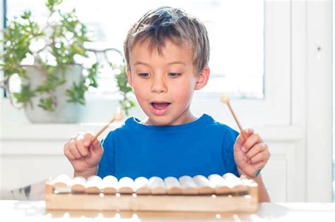 Premium Photo Close Up Of Boy Playing Xylophone