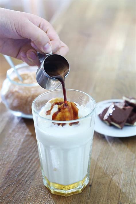 Pour chilled coffee, creamer, and flavored syrup over the ice and stir. Ice Coffee. Coffee With Ice Cream And Whipped Cream. Stock ...