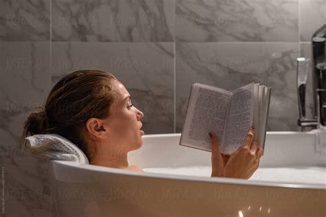Woman Reading Book In Bath Del Colaborador De Stocksy Milles Studio Stocksy