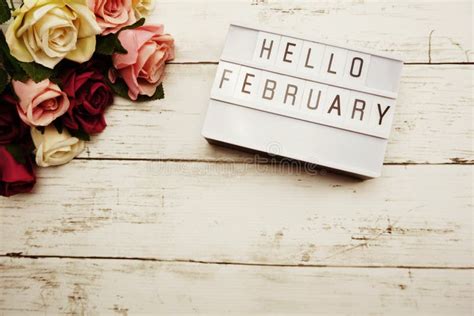 Hello February Word On Light Box With Roses Flower Bouquet On Wooden