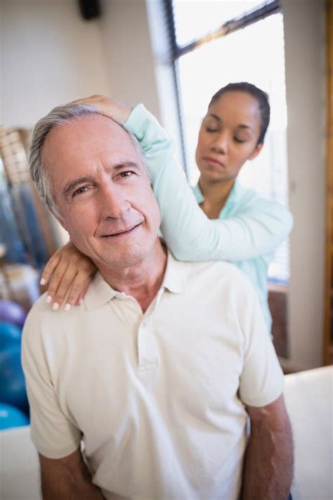 Portrait Of Senior Male Patient Receiving Neck Massage From Female Therapist Stock Image Image