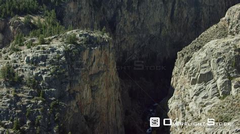 Overflightstock™ A Waterfall Cascades Through A Steep Narrow Canyon On The Edge Of The