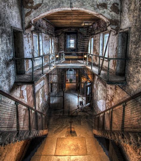 An Old Jail Cell With Stairs And Railings Leading Up To The Second