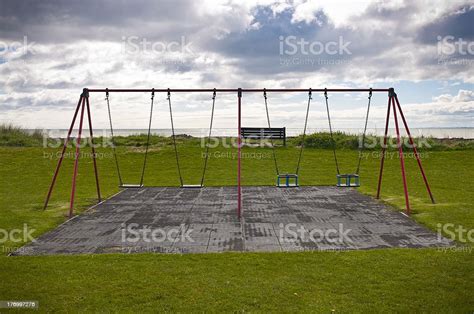 Empty Swings On Grass Play Area Stock Photo Download Image Now