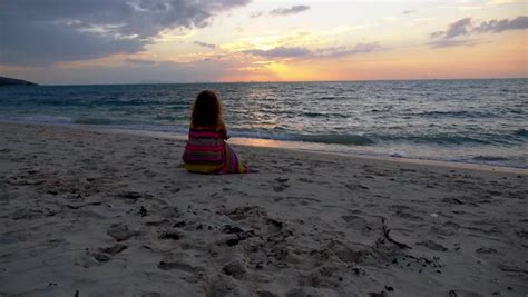 Sad Lonely Woman Standing Alone Against A Beautiful Sunset Stock