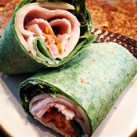 Garden herb spinach wrap with turkey, Swiss cheese, tomato, avocado and