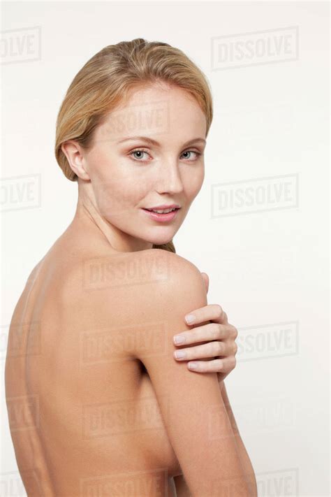 Nude Caucasian Woman Looking Over Shoulder Stock Photo Dissolve