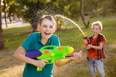 Premium Photo Boys Having Fun Playing With Water Guns