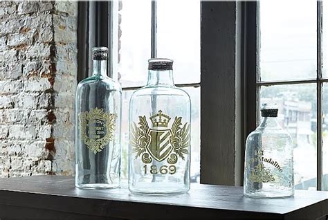 Three Decorative Clear Glass Bottles With Crests And The Year 1869