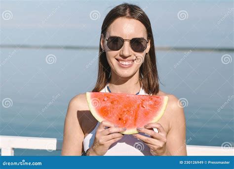 Young Woman With Toothy Smile Holding Slice Of Sweet Juicy Watermelon