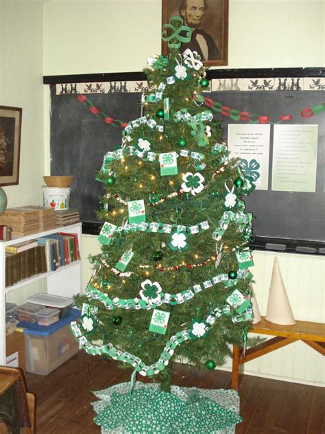 A Decorated Christmas Tree In Front Of A Blackboard