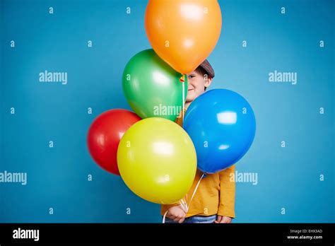 Portrait Of A Little Boy Holding Balloons Stock Photo Alamy
