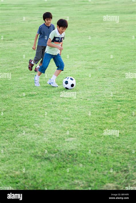 Boys Playing Soccer In Field Copy Space Stock Photo Alamy