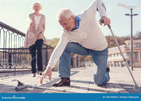 Senior Man Picking Up His Fallen Crutch Stock Photo Image Of Fall