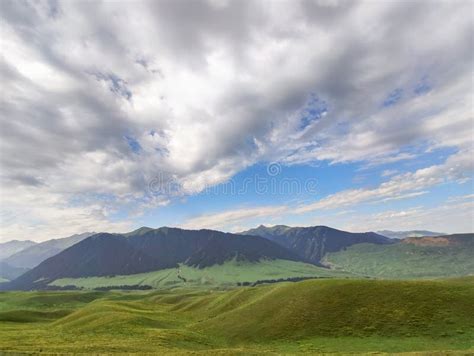 Mountain Nature Landscape With Grassy Green Meadow On Blue Sky