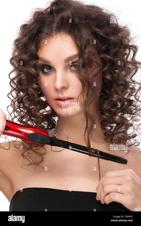 beautiful brunette girl with a perfectly curly hair with curling and classic make up beauty