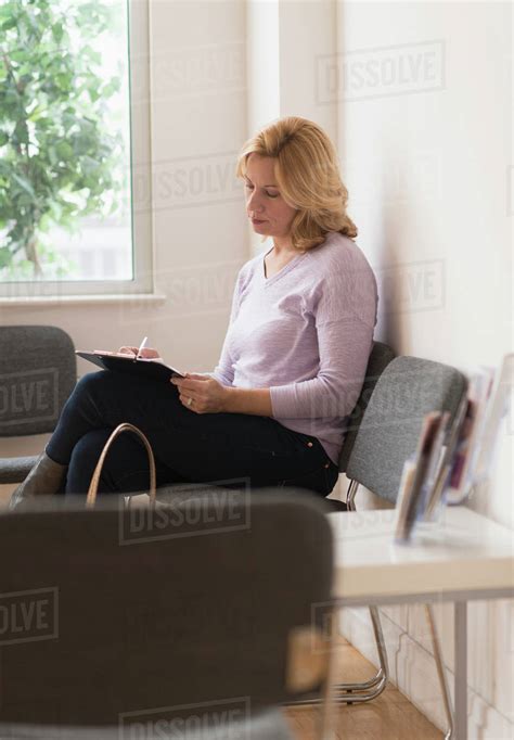 Woman Sitting In Waiting Room Stock Photo Dissolve