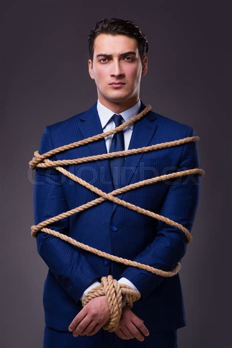 Businessman Tied Up With Rope Stock Photo Colourbox