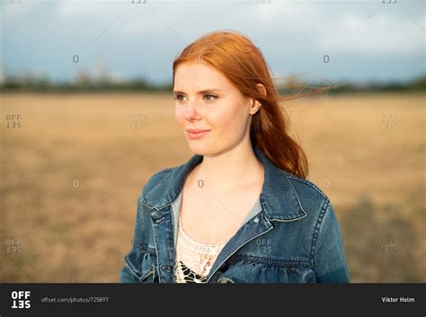 Young Redhead Teenage Girl Wearing Jean Jacket Looking