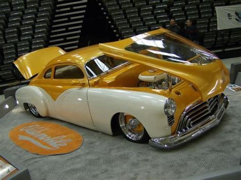 A Yellow And White Car Is On Display