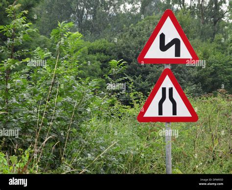 Red Triangle Caution And Warning Road Signs For A Narrowing Road And