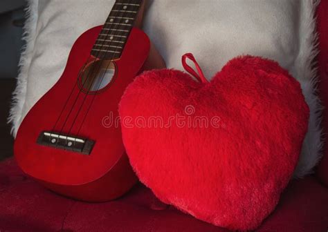 I Love Music Ukulele On Chair With Red Heart Cushion Stock Image