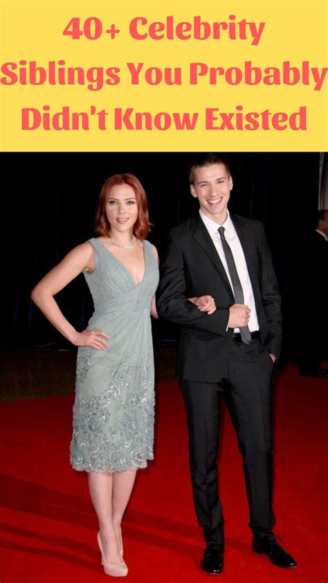 A Man And Woman Standing Next To Each Other On A Red Carpet With The