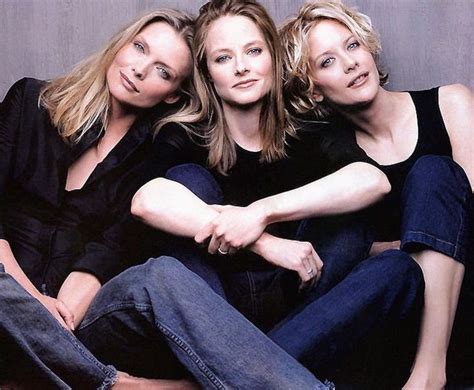 Three Women Are Sitting On The Floor Posing For A Photo With Their Arms